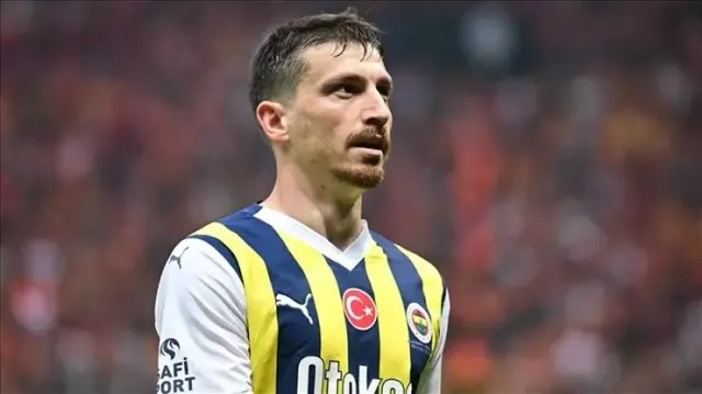 Fenerbahçe’nin sarı-lacivert çubuklu formasıyla Mert Hakan Yandaş, kalabalık tribünün önünde sahada